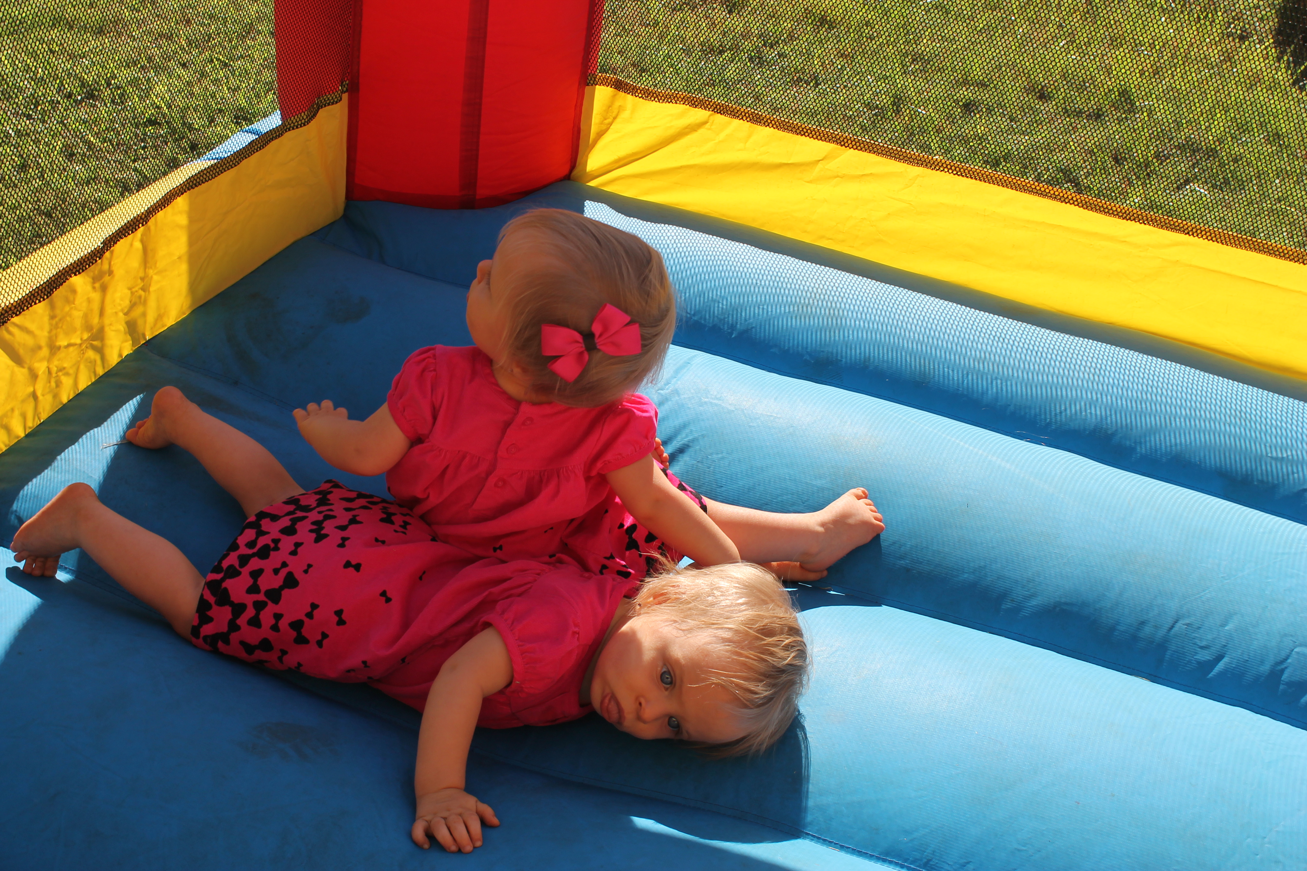 twin girls tired in a bounce house
