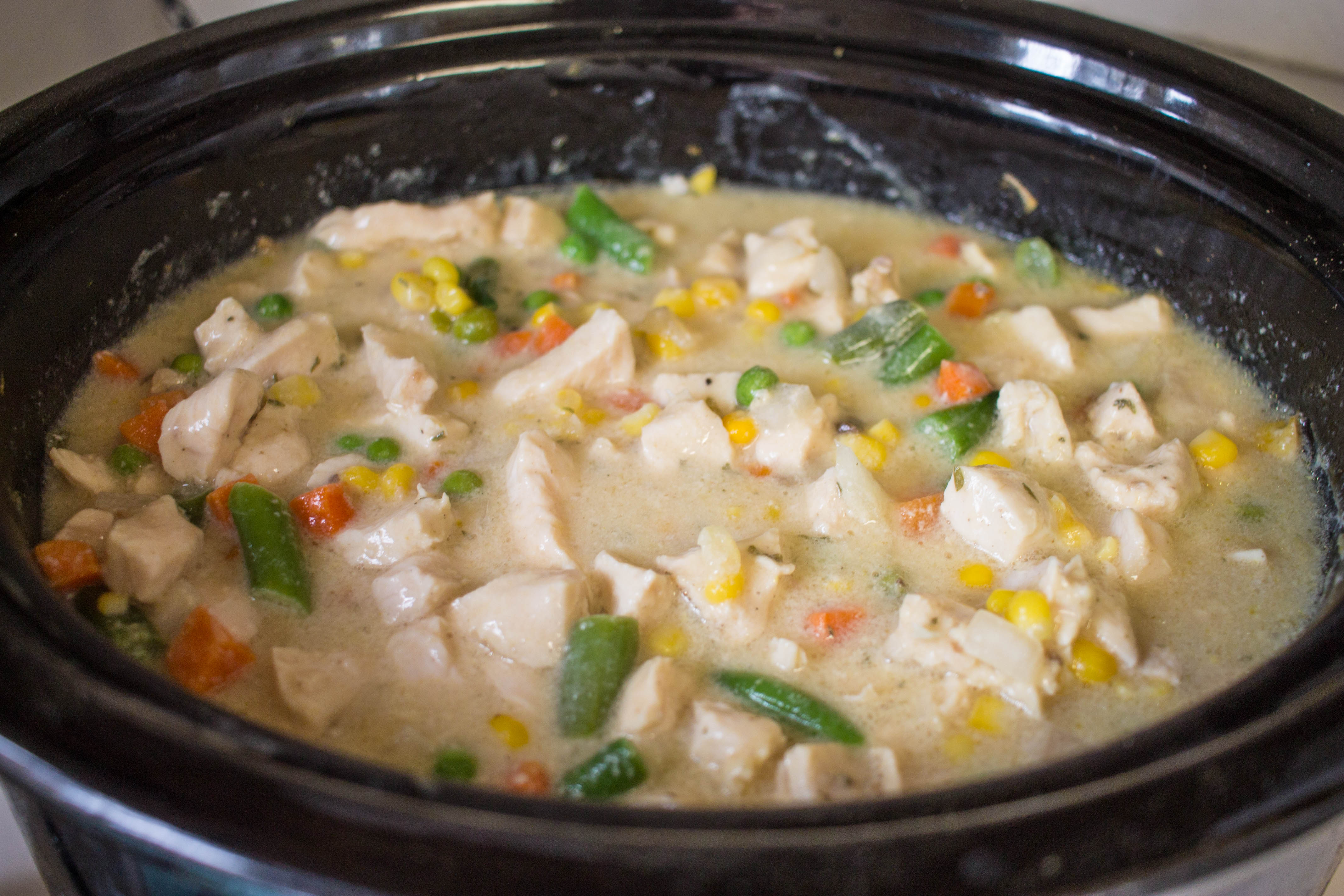 ingredients for crock pot chicken and dumplings cooking in the pot